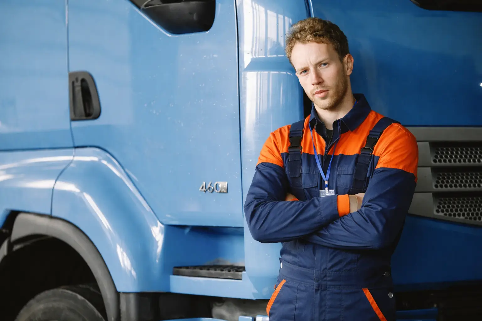 Certified roadside assistance technician standing beside a recovery truck in the UK