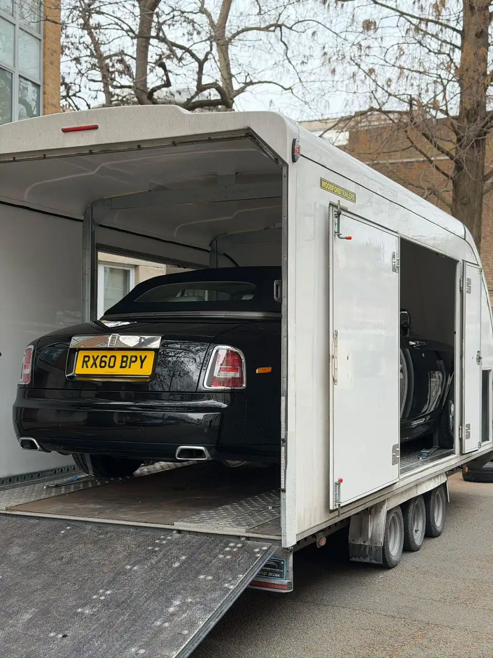 Rolls-Royce being transported in an enclosed Roadway Assist trailer