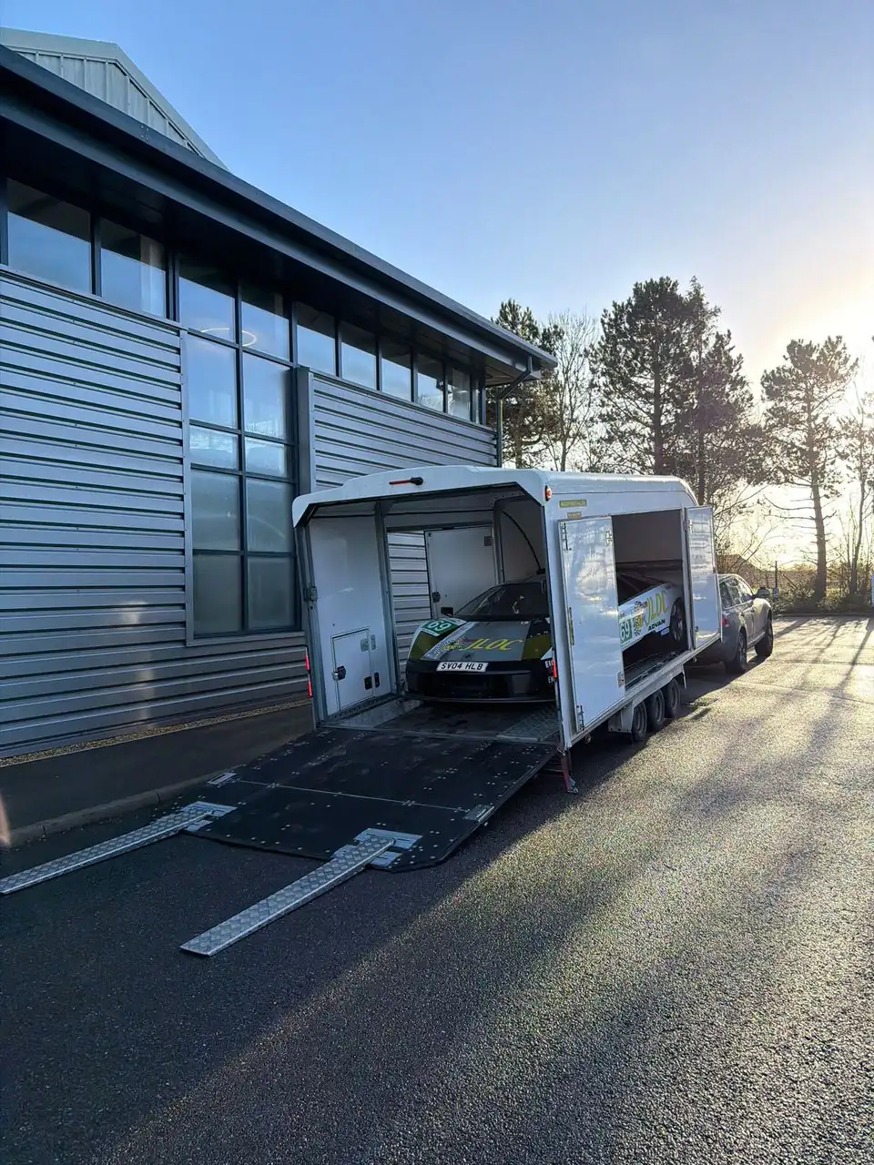 Race car being loaded into an enclosed Roadway Assist transport trailer